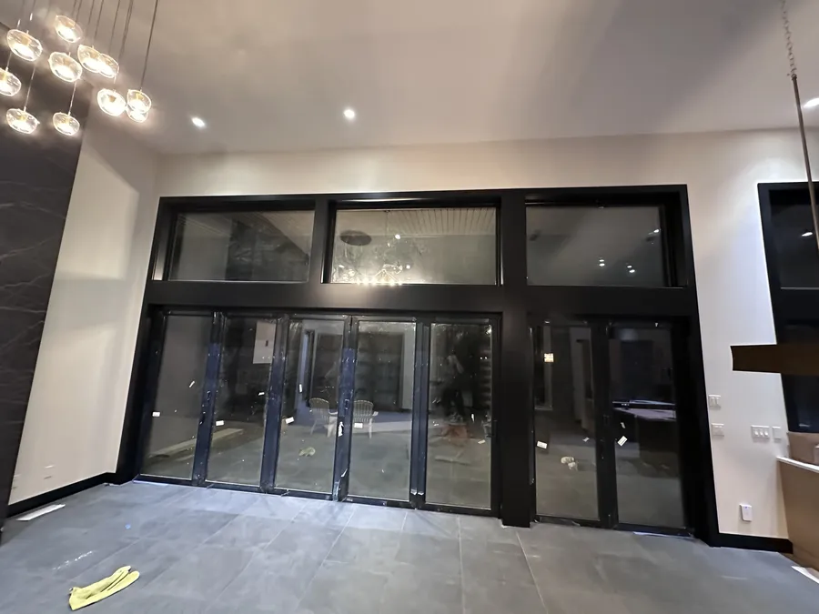Floor-to-ceiling window wall framed in black casing